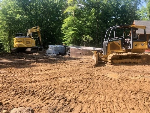 John Deere 450 Bulldozer and Kobelco 140SR Excavator grading at a Clarkston MI swimming pool project